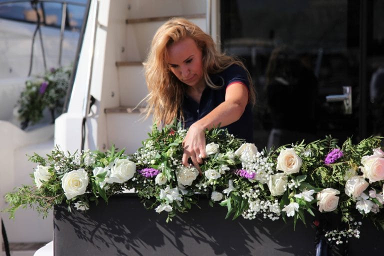 cean Team member arranging flowers onboard the yacht