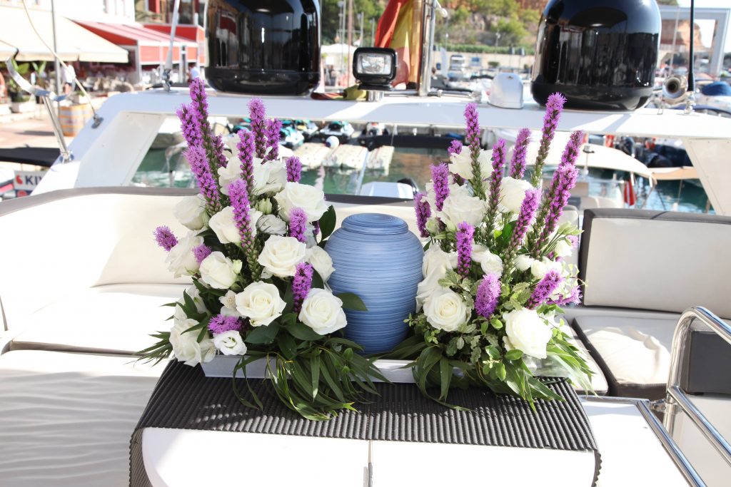 Flower arrangements onboard with the urn as the centerpiece